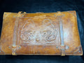Vintage 1930s to 1940s leather suitcase with dragon motif, 25 by 15 by 9 inches